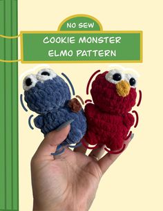 there is a hand holding two small crocheted animals that look like elmo and cookie monster