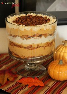 a layered dessert with pumpkins on the table