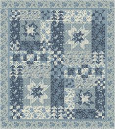 a blue and white patchwork quilt with stars on the front, in various sizes