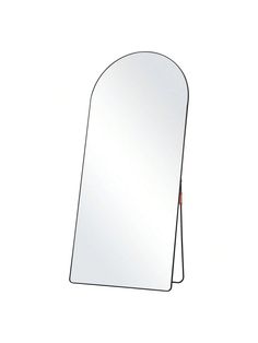 a mirror that is standing up against a white wall and has an arched design on it