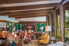 a living room filled with furniture and lots of windows