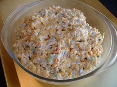 a bowl filled with corn salad on top of a table