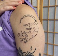 a woman with a tattoo on her arm has a wolf and bird design on it