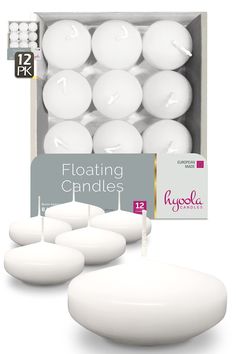 white floating candles are in a box with the package next to it on a white background