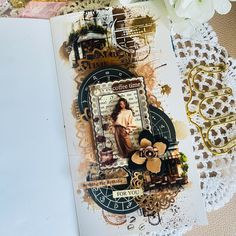 an open book with altered images and doily on the cover, along with flowers