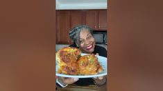 a woman holding a plate with some food on it