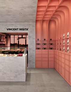 a store with pink walls and shelves filled with items in it's display area