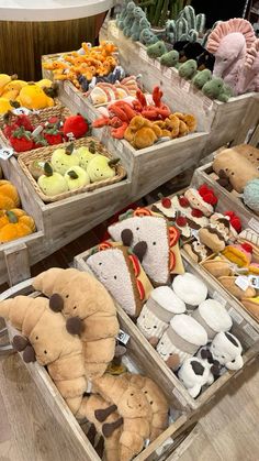 many different types of stuffed animals in wooden boxes