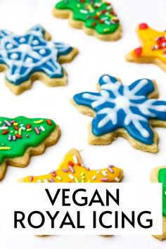 the words vegan royal icing are in front of some decorated sugary cookies