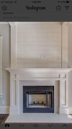 an instagram photo of a fireplace in a living room with white walls and wood floors