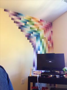 an image of a room with a tv and rainbow wallpaper on the walls in it