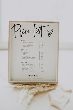 a price list sign sitting on top of a table