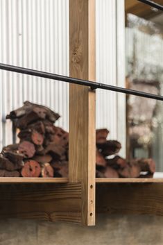 a pile of wood sitting on top of a wooden shelf