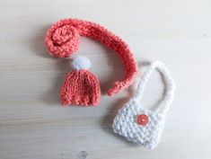 two crocheted purses sitting on top of a wooden table