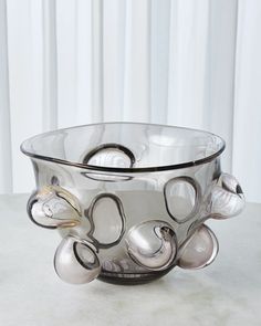 a glass bowl sitting on top of a table