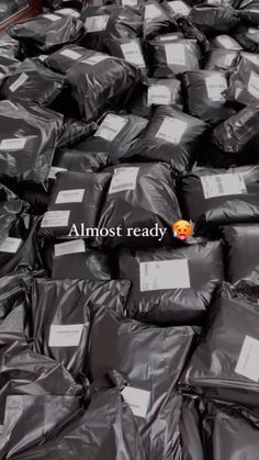 many bags of black plastic are stacked on top of each other with the words almost ready