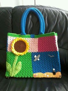 a crocheted bag sitting on top of a couch