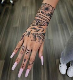 a woman's hand with tattoos on it