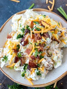 potato salad with bacon and cheese on a white plate