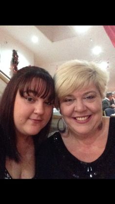 two women are posing for the camera in a restaurant