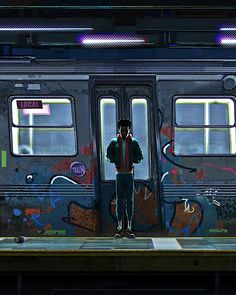 a man standing in front of a subway car with graffiti on the wall behind him