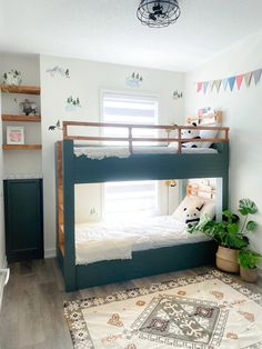 there is a bunk bed in the children's room with plants on the floor