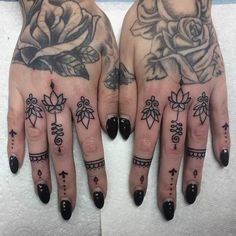 two hands with tattoos on them, one has a rose and the other has an arrow