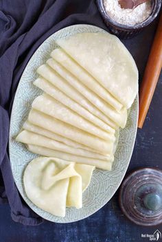 several pieces of flat bread on a plate next to some salt and pepper shakers