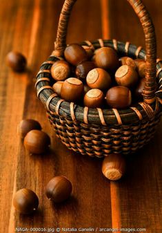 a basket filled with nuts sitting on top of a wooden table