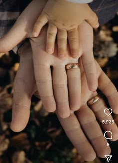 two hands holding each other with wedding rings on them