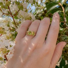 Good things come in threes, and this vintage peridot ring is no exception. This piece features three pristine oval peridots set in a classic trilogy style. Peridot is the birthstone for August and a popular gift for 16th wedding anniversaries. It symbolizes strength, happiness, and good fortune. Comes with a complimentary paper ring box. Click here to upgrade to a signature ring box. Materials & Measurements: Vintage. 14k yellow gold. 3 oval peridots. Size 6. Details: There is a 4 week lead time Peridot Rings Vintage, Peridot Engagement Rings Diamond, 16th Wedding Anniversary, Signature Ring, Signature Rings, Trilogy Ring, Paper Ring, Peridot Ring, Body Chain Jewelry