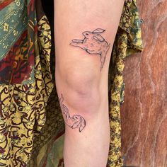 a woman's leg with a tattoo of a dog on the left side of her leg