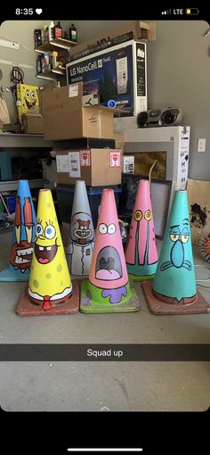 several different colored cones with cartoon characters on them sitting in front of a computer desk