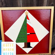 a handmade christmas card with a red background and a green tree on the front