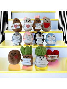 several crocheted stuffed animals are sitting on the steps with cards attached to them