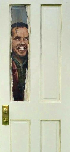 a door with a cut out image of a man's face on it