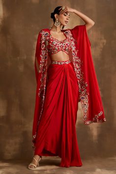 Buy Red Silk Crepe And Organza Embroidered Blossom Border Draped Skirt Set For Women by Niamh By Kriti Online at Aza Fashions. Asymmetric Cape, Indo Western Outfits For Women, Organza Cape, Mehendi Outfits, Indian Bridal Lehenga, Traditional Indian Dress, Padded Blouse