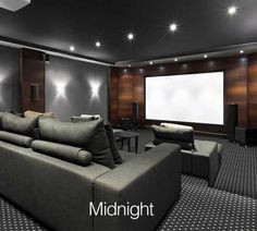 a large living room with couches and a projector screen