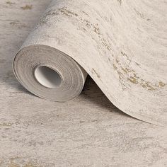 a roll of paper that is on top of a wallpaper covered in white paint