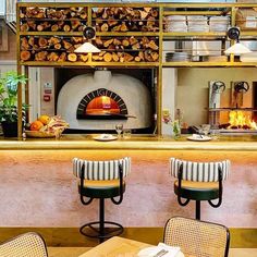 a restaurant with tables and chairs in front of an oven