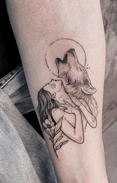 a woman with a wolf tattoo on her arm and the moon above her head is shown