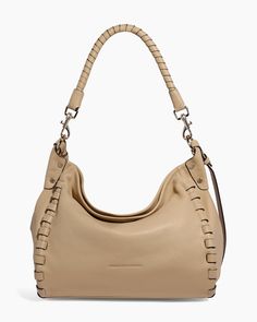 Soft and slouchy, the Zen Hobo is the perfect piece for casual everyday styling. With a braided shoulder strap and adjustable crossbody strap, it can be worn multiple ways. Glove tanned leather Signature branded hardware Magnetic snap entry Interior: 1 zipper pocket, 1 slip pocket Exterior: 1 zipper pocket Handle: 6.5" drop Strap: detachable and adjustable 25" - 28" 10.24"L x 11"H x 3.25"W Weight approximately: 1.6lbs Leather Hobo Bags, Hobo Tote Bag, The Zen, Leather Hobo, Leather Care, Casual Everyday, Crossbody Strap, Belt Bag, Tan Leather