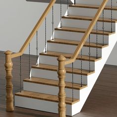 an empty staircase with wooden handrails and white walls