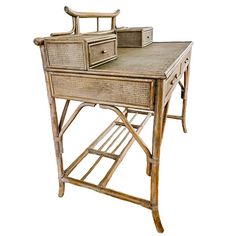 an old bamboo desk with two drawers and a drawer on it's end table