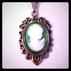 This Is A Gorgeous Handmade Superbly Detailed Cameo! From Her Hair, To The Roses On Her Dress, To Her Dainty Detailed Pearl Necklace! This Beautiful Green Cameo Is 1 1/8h X 3/4"W And Is Suspended From An 18" 925 Sterling Silver Chain With A Lobster Claw Clasp. Excellent Gift For Yourself Or Your Loved Ones! Comes Already Gift Wrapped And In A Fancy Gold Gift Box! Comes From A Smoke And Pet Free Environment. Please Ask Any Questions You Have. Offers Welcome! Bundle Items From My Closet And Save! Silver Cameo Medallion Necklace, Silver Cameo Pendant Necklace, Silver Cameo Round Pendant Jewelry, Silver Cameo Jewelry With Round Pendant, Round Silver Cameo Necklace, Classic Cameo Necklace For Gift, Classic Cameo Necklace As Gift, Vintage Necklaces Stamped 925, Silver Cameo Oval Pendant Jewelry