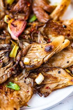 a white plate topped with meat and veggies