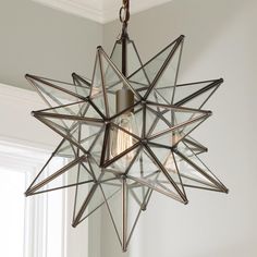 a star shaped light fixture hanging from the ceiling