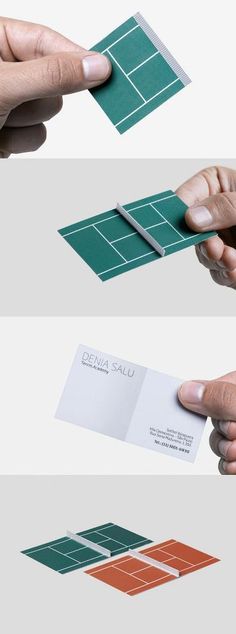 two hands are holding business cards and pointing them at the same card on each side