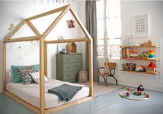 a child's bedroom with a doll house on the floor