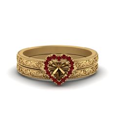 a gold ring with a heart and cross in the middle, surrounded by filigrees